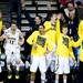 The Michigan bench celebrates a three-point-shot in the game against Virginia Commonwealth on Saturday, March 23. Michigan won 78-53. Daniel Brenner I AnnArbor.com